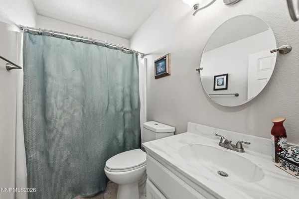 a bathroom with a sink a mirror a toilet and a mirror