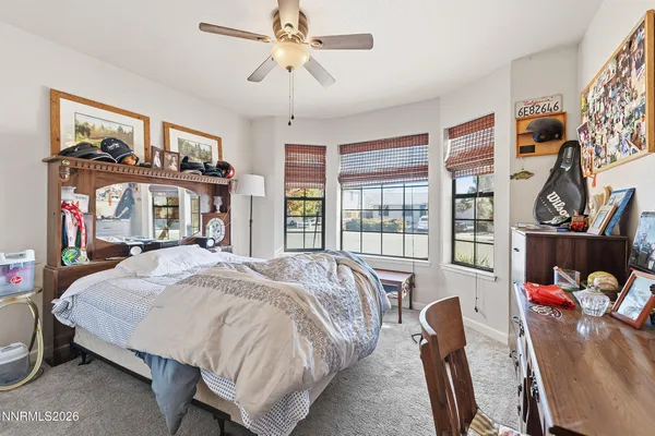a bed sitting in a bedroom next to a window