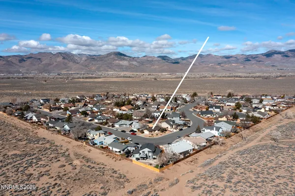 a view of a house with a yard and wooden fence