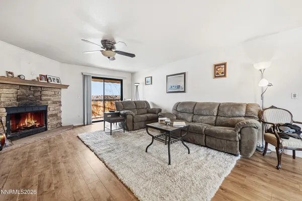 a living room with furniture a rug and a fireplace