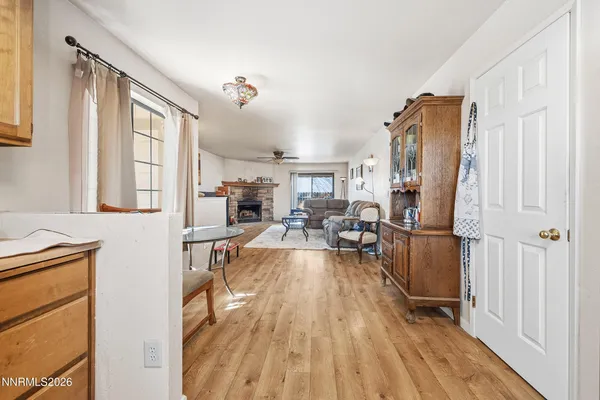 a living room with furniture a large window and wooden floor