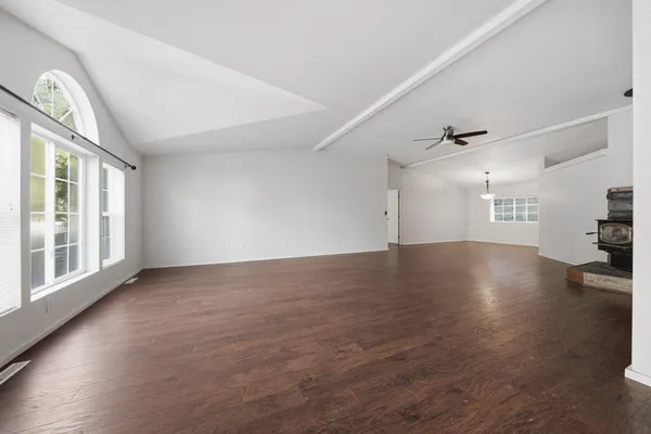 a kitchen with granite countertop a sink cabinets stainless steel appliances and a window