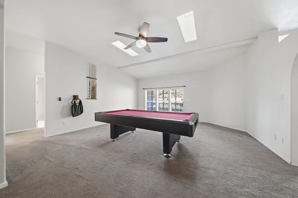 a white bath tub sitting in a bathroom and mirror