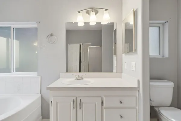 a white bath tub sitting next to a shower