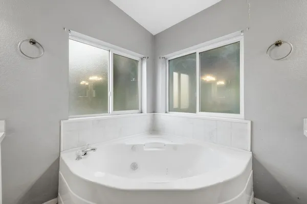 a view of a hallway with wooden floor and entryway