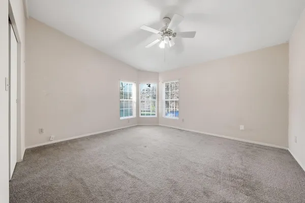 a view of deck with a yard and wooden fence
