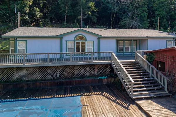 a view of a balcony with wooden floor and fence