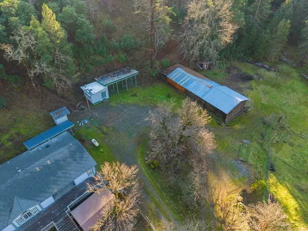 a living room with furniture kitchen view and a large window