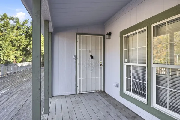 a kitchen with granite countertop white cabinets and wooden floor