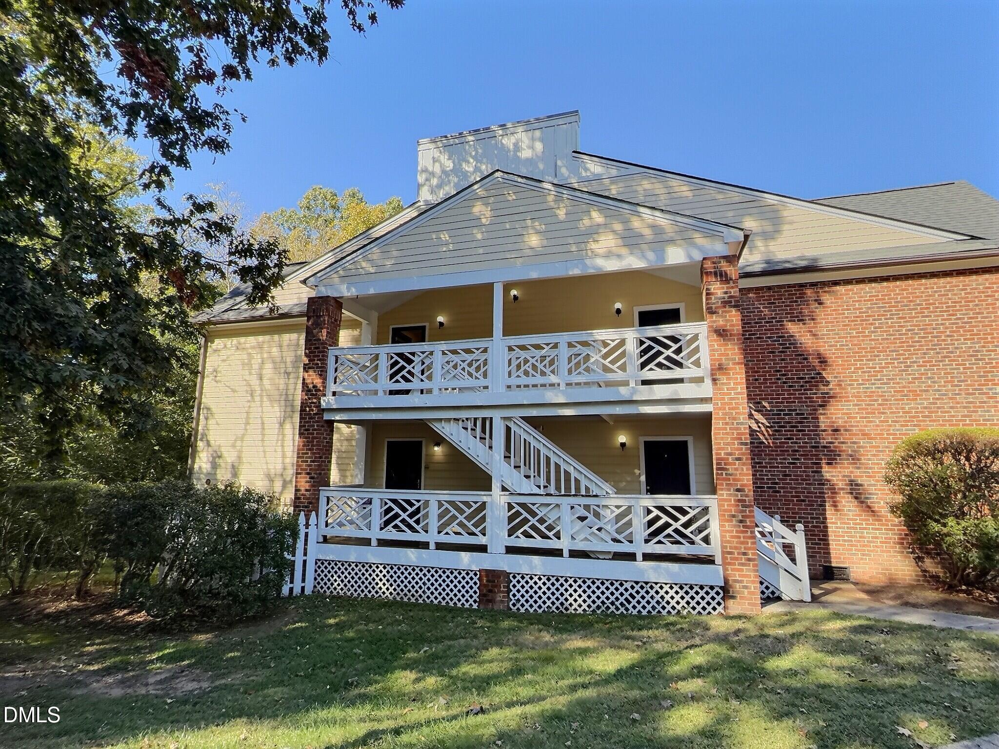 1003 Kingswood Drive, Unit N Chapel Hill, NC 27517 - Photo 1 of 23 a front view of a house with a yard