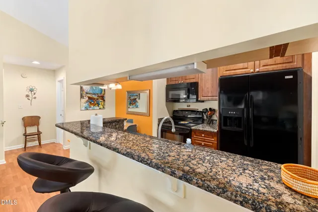 a kitchen with stainless steel appliances kitchen island granite countertop a sink and cabinets