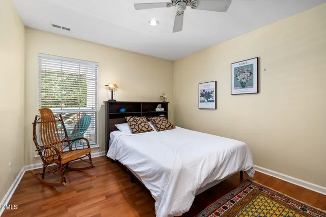 a bedroom with a bed a chair and a window