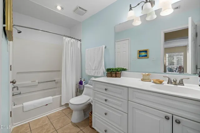 a bathroom with a toilet a sink and a mirror