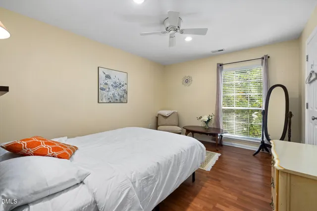 a bedroom with a bed and a large window