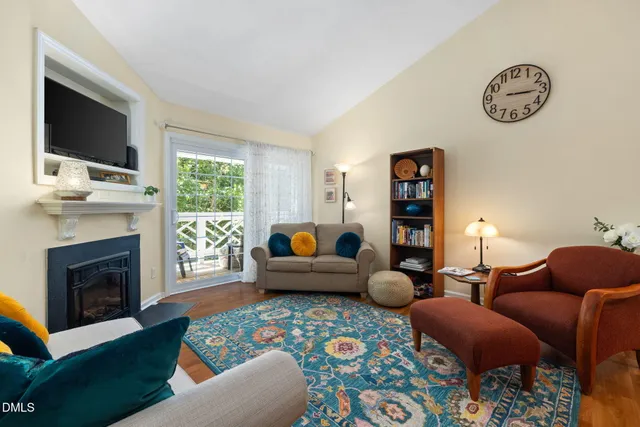 a living room with furniture fireplace and window