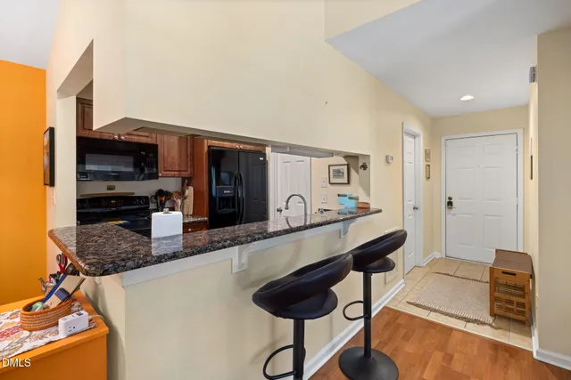 a kitchen with granite countertop a counter space cabinets and stainless steel appliances