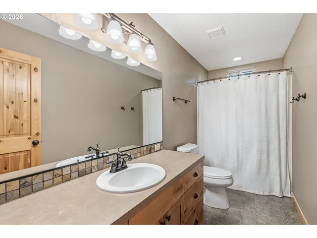 a bathroom with a double vanity sink mirror and double