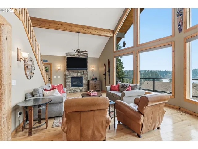 a living room with fireplace furniture and a large window
