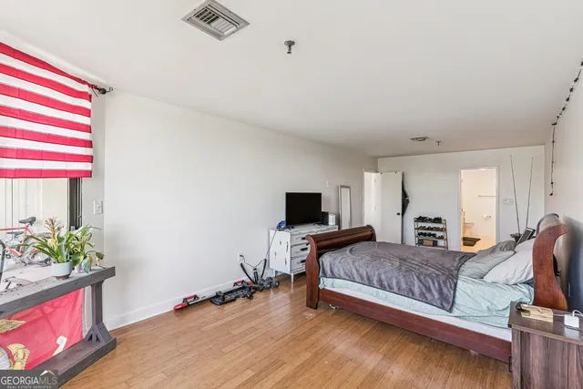 a bedroom with bed and window