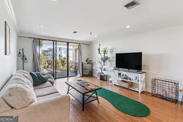 a living room with furniture flat screen tv and a large window