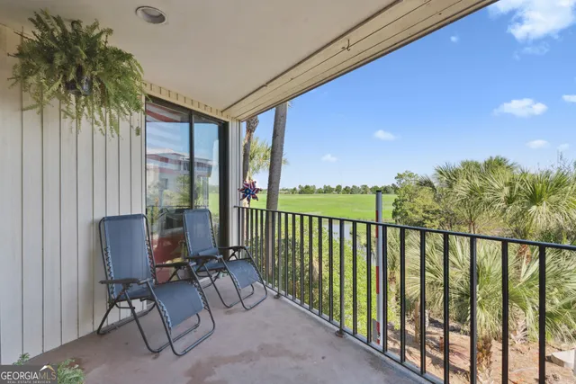 a view of balcony with furniture and a potted plant