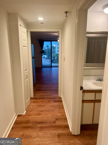 a view of a hallway with wooden floor and staircase