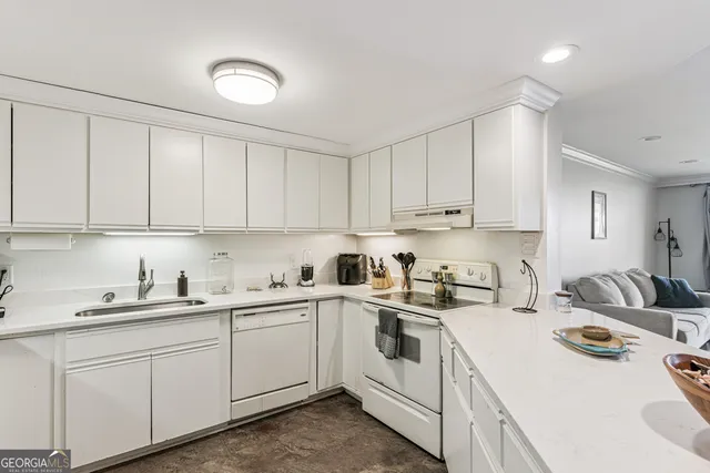 a kitchen with a sink a stove and cabinets