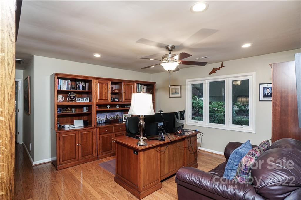 8032 Windjammer Drive Tega Cay, SC 29708 - Photo 13 of 48 a living room with furniture a flat screen tv and a bookshelf