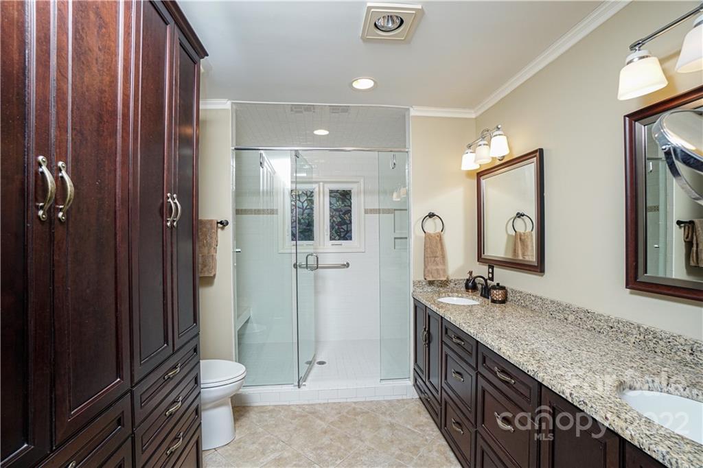 8032 Windjammer Drive Tega Cay, SC 29708 - Photo 16 of 48 a spacious bathroom with a granite countertop sink mirror and toilet