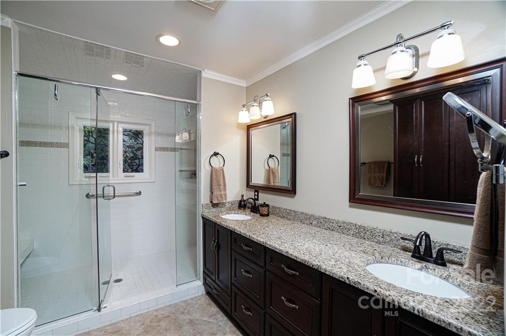 8032 Windjammer Drive Tega Cay, SC 29708 - Photo 17 of 48 a bathroom with double sink and a mirror