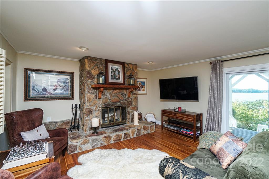 8032 Windjammer Drive Tega Cay, SC 29708 - Photo 28 of 48 a living room with furniture a flat screen tv and a fireplace