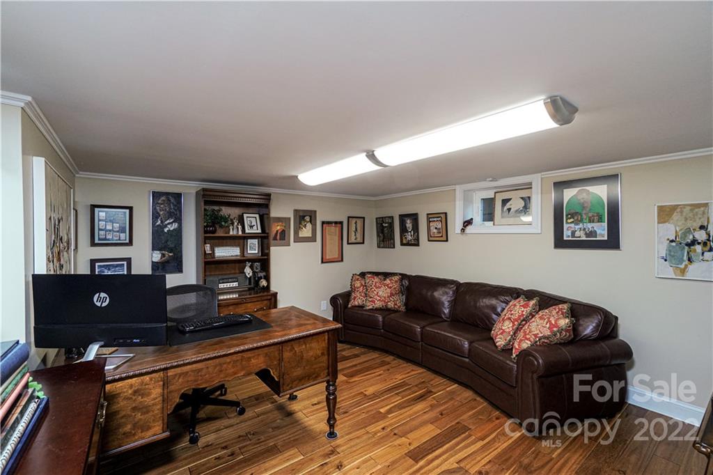 8032 Windjammer Drive Tega Cay, SC 29708 - Photo 29 of 48 a living room with furniture and a wooden floor