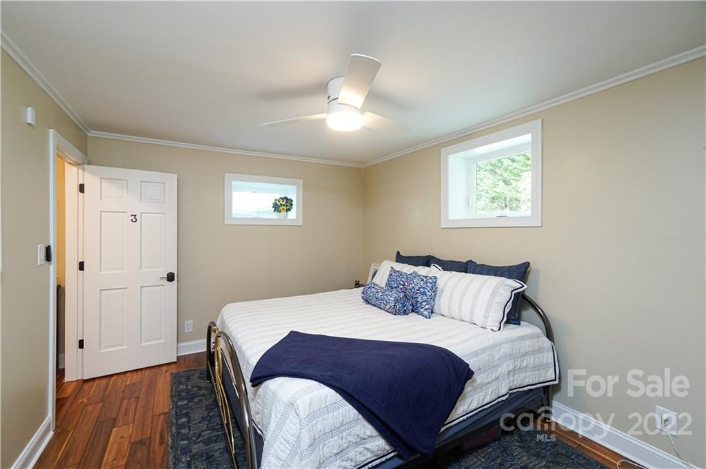 8032 Windjammer Drive Tega Cay, SC 29708 - Photo 34 of 48 a bedroom with a bed and wooden floor