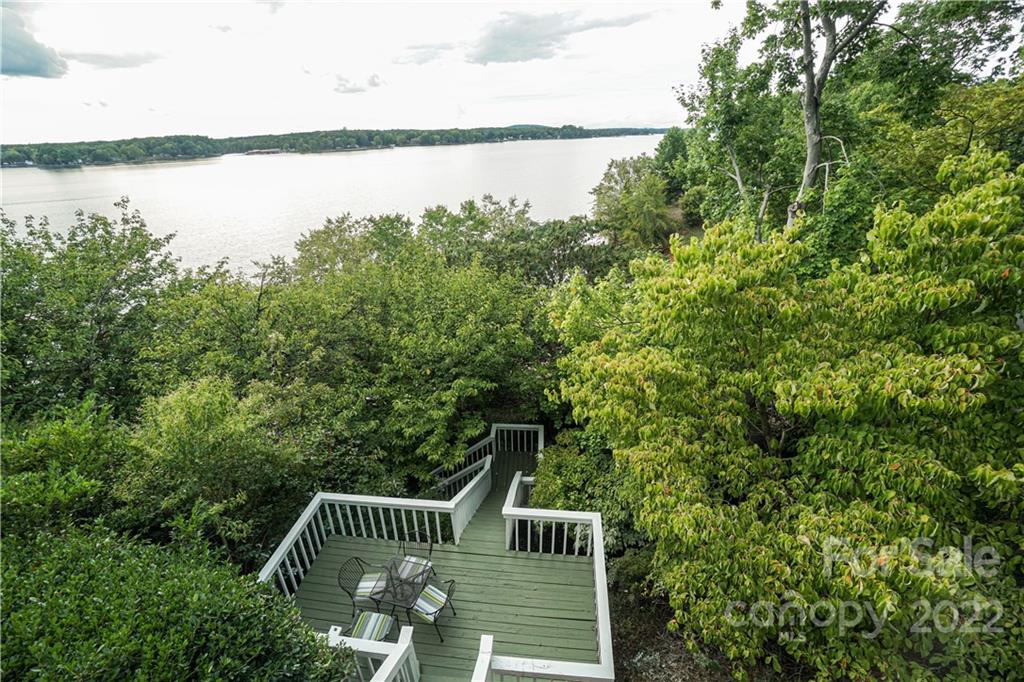 8032 Windjammer Drive Tega Cay, SC 29708 - Photo 39 of 48 a view of a deck in backyard of house with outdoor seating