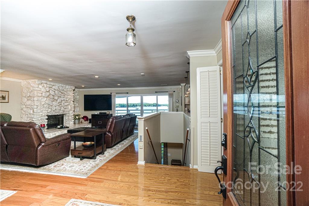 8032 Windjammer Drive Tega Cay, SC 29708 - Photo 5 of 48 a living room with furniture a flat screen tv and a fireplace