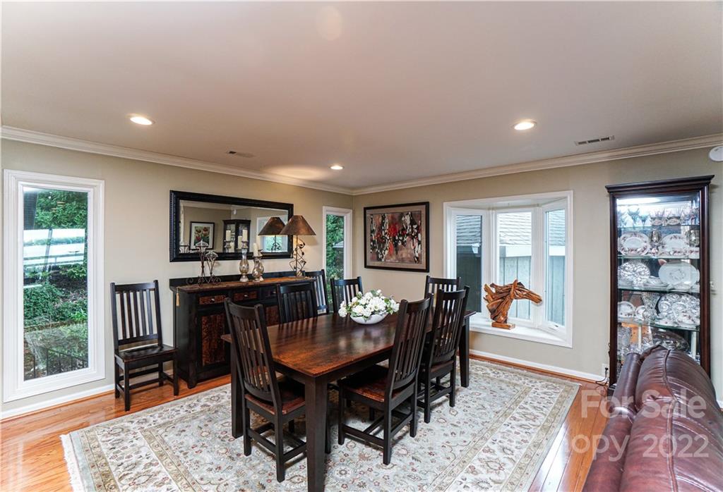 8032 Windjammer Drive Tega Cay, SC 29708 - Photo 6 of 48 a view of a dining room with furniture window and wooden floor