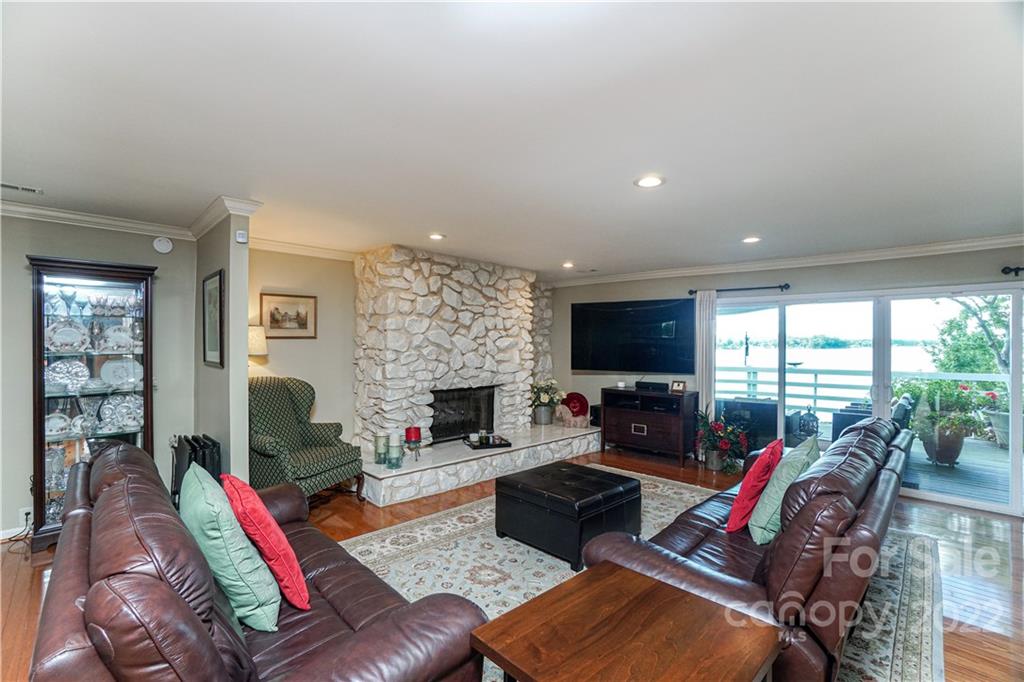 8032 Windjammer Drive Tega Cay, SC 29708 - Photo 7 of 48 a living room with furniture fireplace and a flat screen tv