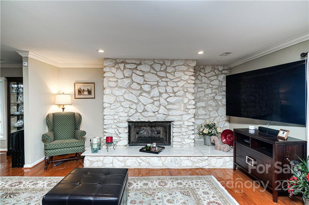 8032 Windjammer Drive Tega Cay, SC 29708 - Photo 8 of 48 a living room with furniture a flat screen tv and a fireplace