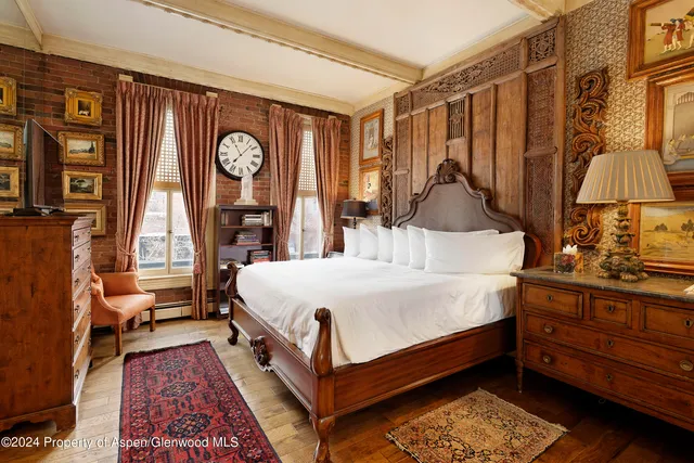 a bed room with a bed and a chandelier