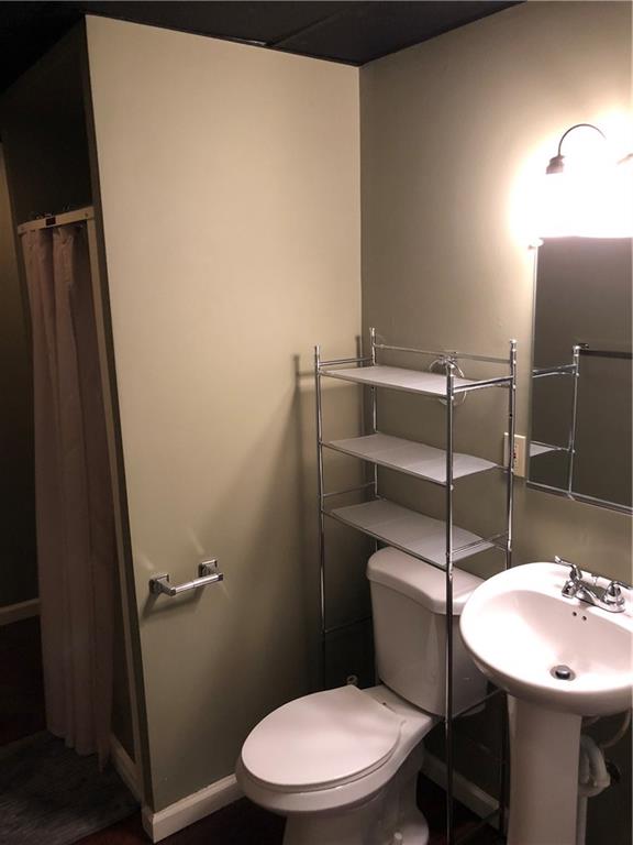 350 Jefferson Street Rochester, PA 15074 - Photo 9 of 19 a bathroom with a sink a toilet a mirror and shower