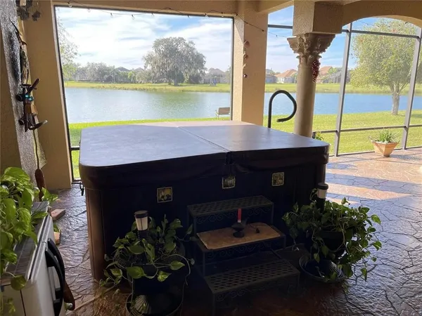 a front view of a house with a garden and lake view