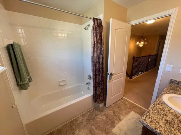 a bathroom with a tub and a shower