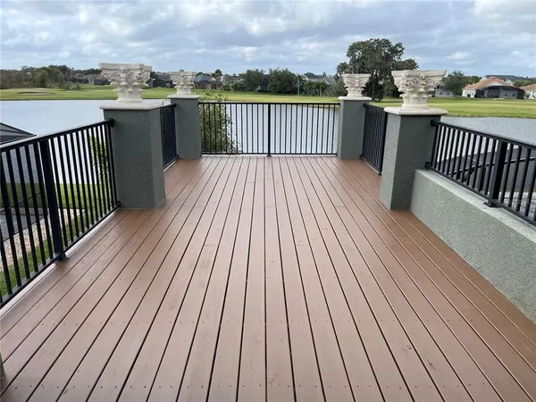 a balcony with wooden floor and city view