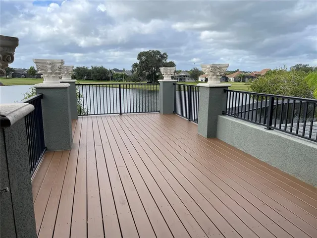 a view of a roof with wooden floor and city view