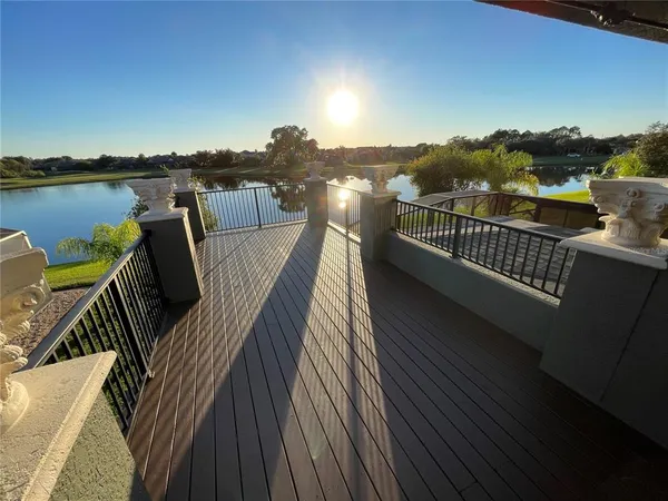 a view of a balcony with wooden floor and city view