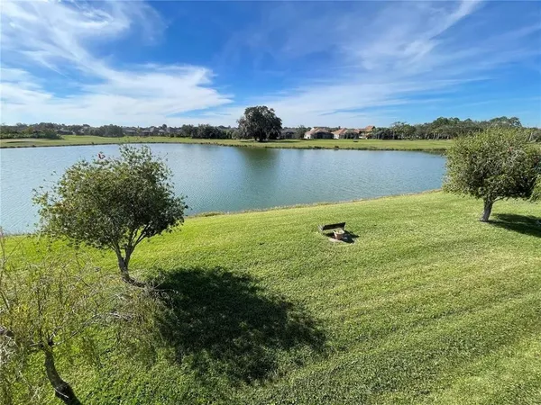 a view of a lake with houses in the back