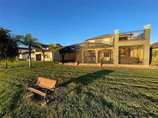a view of a house with a backyard
