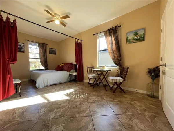 a bedroom with furniture and a window