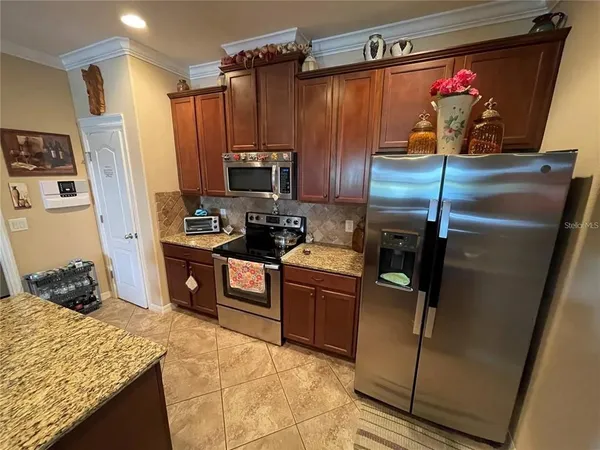 a kitchen with stainless steel appliances granite countertop a refrigerator and a stove