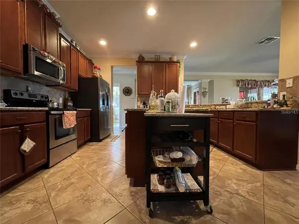 a kitchen with stainless steel appliances granite countertop a sink counter space and cabinets